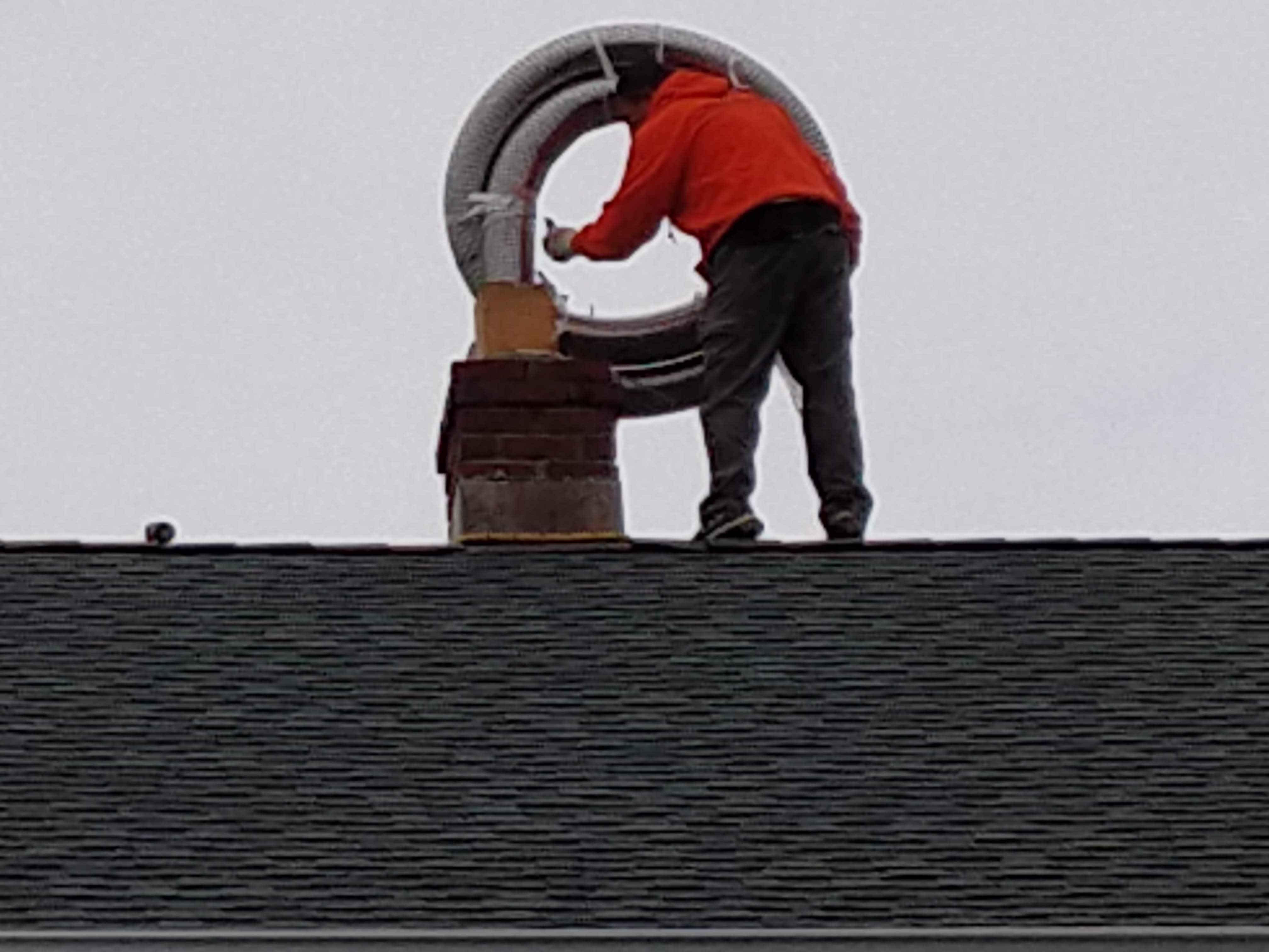 Flexible stainless chimney liner being installed in Albertson, New York